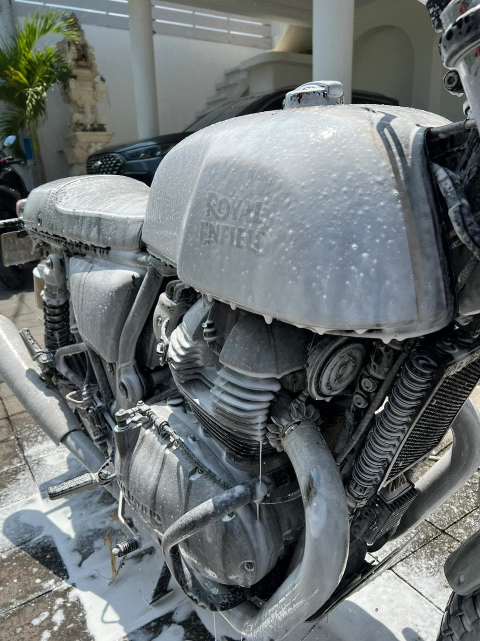 Motorbike covered in snow foam during a SparkWash wash in Canggu, Bali